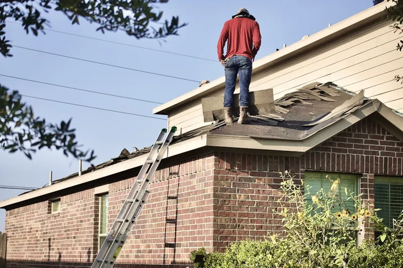 Professional roofer working on a residential roof in Ryeland